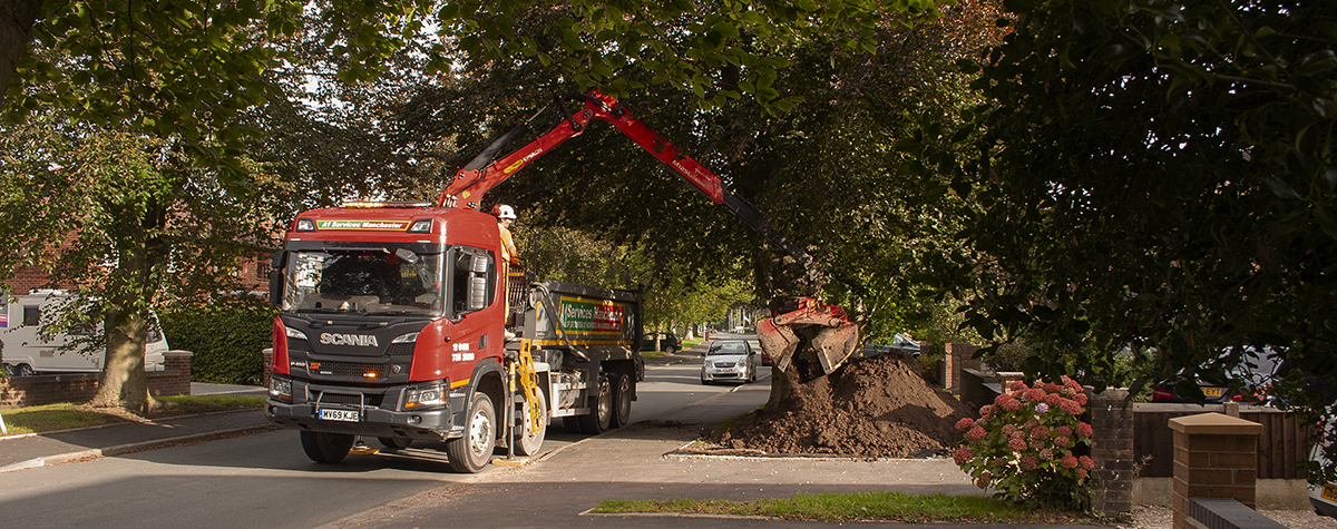 One of our grab trucks delivering top soil for a landscaping project.